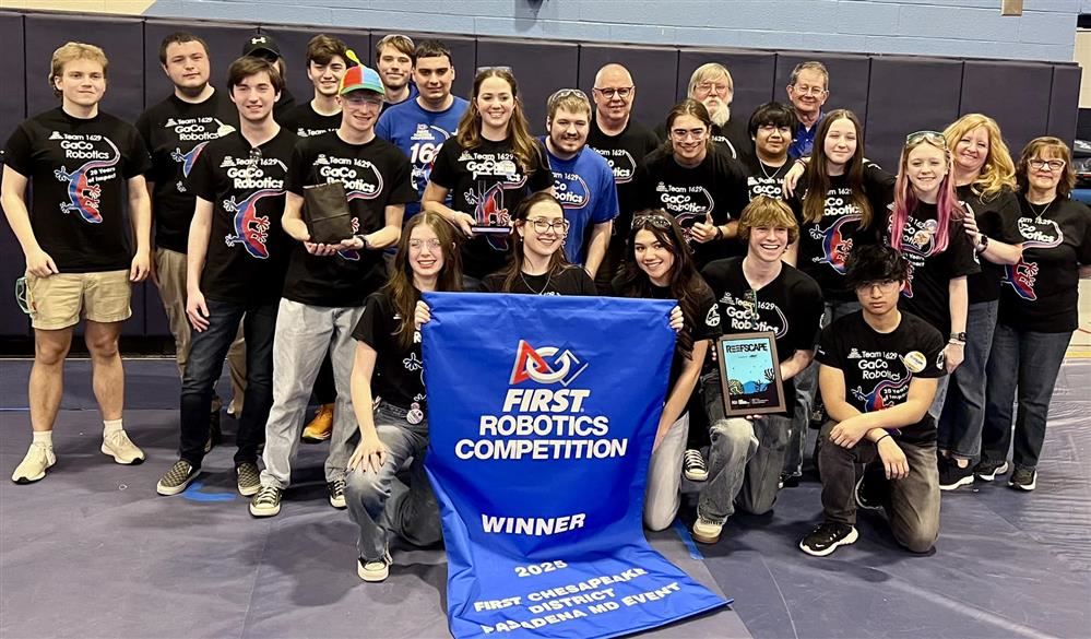  Image of robotics Team 1629 posed with their winning banner as detailed in the story.